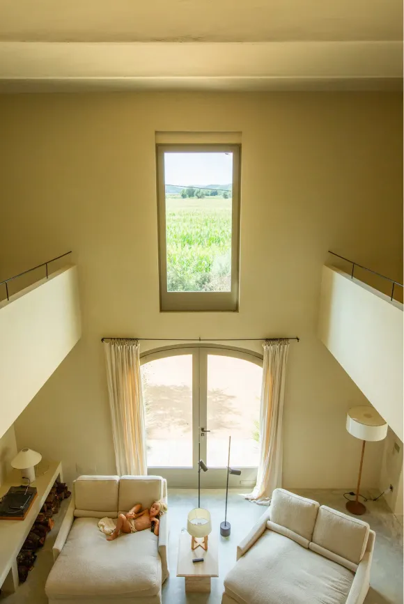 double height living room with fireplace Casa Carolina house in Emporda Spain with pool rustic chic decor