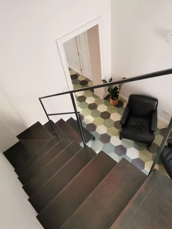 stairs green terracotta tiles apartment in Italy in a period palace designer decor